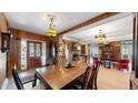 Elegant dining room featuring a large wooden table, vintage decor, and an open floor plan at 30094 Upper Bear Creek Rd, Evergreen, CO 80439