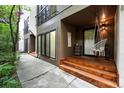Side view of the front entrance with wooden steps, a hanging chair, and modern facade at 960 N Pennsylvania St # 6, Denver, CO 80203