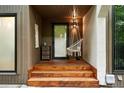 Close-up of the front entrance with wooden steps and a hanging swing chair at 960 N Pennsylvania St # 6, Denver, CO 80203