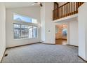 Bright, airy living room featuring large windows, vaulted ceiling, carpeted floors, and an open layout at 11580 Depew Ct, Westminster, CO 80020