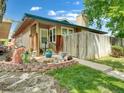 Charming home featuring a lush front yard with healthy lawn, walkway and inviting landscaping at 8730 E Roundtree Ave, Greenwood Village, CO 80111