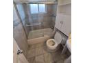 Clean bathroom with tiled shower-tub combo and glass door at 588 Empire St, Aurora, CO 80010