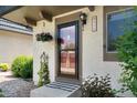 Close-up of the front door with a hanging flower basket and visible house number at 6856 S Broadway, Centennial, CO 80122