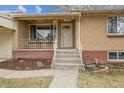 Charming front porch with brick accents, iron railings, and a mid-century modern feel at 4940 Fenton St, Denver, CO 80212