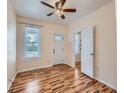 Bright bedroom featuring hardwood floors, a ceiling fan, and ample natural light from the large window at 66 E 45Th Ave, Denver, CO 80216