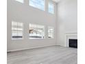 Spacious living room with tall ceilings, ample windows, a fireplace, and laminate flooring at 4741 Twelve Oaks Way, Castle Rock, CO 80104