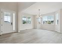 Bright living room featuring expansive windows and light wood-look floors at 4741 Twelve Oaks Way, Castle Rock, CO 80104