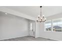 Inviting living room featuring a chandelier, light wood-look floors, and neutral walls at 4741 Twelve Oaks Way, Castle Rock, CO 80104