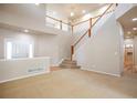Inviting entrance with a staircase, neutral carpeting, and natural light welcomes you into the home at 21286 E Nassau Ave, Aurora, CO 80013
