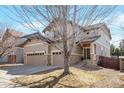 Attractive two-story home featuring a three-car garage, and neutral tones, surrounded by mature landscaping at 21286 E Nassau Ave, Aurora, CO 80013