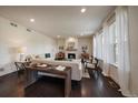 Inviting living room showcases a fireplace and hardwood floors, perfect for entertaining and relaxation at 16062 Red Bud Loop, Parker, CO 80134