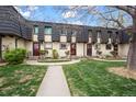 Inviting townhouse exterior featuring manicured lawns and tidy landscaping at 6930 S Broadway, Centennial, CO 80122