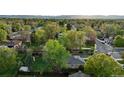 Residential neighborhood aerial view showcases mature trees, lawns, and diverse housing at 6390 W 47Th Ave, Wheat Ridge, CO 80033