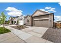 A well-manicured front yard and stone facade enhance the curb appeal of this charming single-Gathering home at 9313 Biscay St, Commerce City, CO 80022