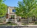 Charming two-story home with a manicured front yard and white picket fence under a bright blue sky at 9338 W 107Th Mews, Westminster, CO 80021