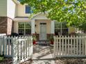Inviting home with a white picket fence, well-kept landscaping, and a welcoming entryway at 9338 W 107Th Mews, Westminster, CO 80021