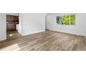Inviting living area with wood-look floors, neutral walls, and a large window at 1235 S Benton St, Lakewood, CO 80232