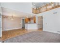 Spacious living room featuring hardwood floors, and an open layout connecting to the kitchen at 19232 E Adriatic Pl, Aurora, CO 80013