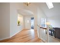 Bright foyer with hardwood floors, vaulted ceilings, and decorative niche at 7311 Brixham Cir, Castle Pines, CO 80108