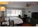 Bright bedroom features wood floors, ceiling fan, and large window with natural light at 1421 N Pearl St # 2, Denver, CO 80203