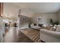 Cozy living room features neutral paint, hardwood floors, and comfortable seating perfect for relaxation at 10859 W Fair Ave, Littleton, CO 80127