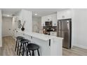 Modern kitchen with stainless steel appliances, white cabinetry, and a breakfast bar with stylish seating at 7970 Chase Cir # 85, Arvada, CO 80003