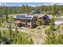 A stunning aerial view of a luxury home nestled amongst trees with a mountain view at 41 Barton Ridge Dr, Breckenridge, CO 80424