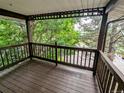 A cozy wooden balcony with views of lush greenery and trees at 17361 E Mansfield Ave # 532R, Aurora, CO 80013