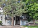 Building exterior featuring private balconies surrounded by mature trees at 17361 E Mansfield Ave # 532R, Aurora, CO 80013