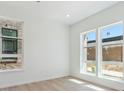 Bright bedroom with large windows and wood flooring at 11481 E Briarwood Cir, Centennial, CO 80112