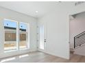 The entryway showcases two large windows, an exterior door, and a modern black railing staircase at 11481 E Briarwood Cir, Centennial, CO 80112