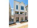 Contemporary townhome with brick base, large windows, and well-manicured landscaping at 11481 E Briarwood Cir, Centennial, CO 80112