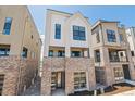 Modern townhome features brick base, ample windows, and inviting curb appeal at 11481 E Briarwood Cir, Centennial, CO 80112