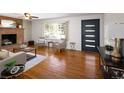 Bright living room with hardwood floors, brick fireplace, and ample natural light at 8100 W 8Th Ave, Lakewood, CO 80214