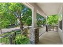 Inviting front porch with stone accents, offering a cozy outdoor space and neighborhood views at 6055 W Progress Ave, Littleton, CO 80123