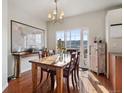 Bright dining room with wooden table, access to deck, and mountain views at 985 Burning Bush Pt, Monument, CO 80132