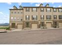 Townhome complex with multiple units, garages, and mountain views at 985 Burning Bush Pt, Monument, CO 80132