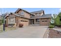 Charming two-story home with a brick and siding exterior and attached garages at 26741 E Arbor Dr, Aurora, CO 80016