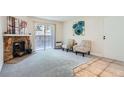 Cozy living room with a stone fireplace, sliding glass doors, and neutral decor at 15136 E Louisiana Dr # 106, Aurora, CO 80012