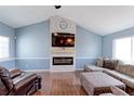 Stylish living room featuring a fireplace, modern furnishings, and plenty of natural light at 11537 Macon St, Commerce City, CO 80640