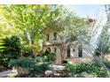 Inviting two-story home with lush landscaping, mature trees, and well-maintained lawn showcasing curb appeal at 2435 S Milwaukee St, Denver, CO 80210