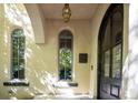 Charming front porch with arched entry, stone accents, and decorative lighting creating an inviting entrance at 2435 S Milwaukee St, Denver, CO 80210