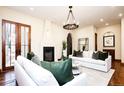 Comfortable living room featuring hardwood floors, fireplace, white sofas, and stylish decor creating inviting space at 2435 S Milwaukee St, Denver, CO 80210