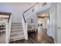 Bright entryway with hardwood floors, staircase, and bench at 6474 S Jericho Cir, Centennial, CO 80016