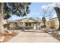 Charming single-story home with stone accents, a well-maintained lawn, and a spacious driveway perfect for parking at 404 S Jasmine St, Denver, CO 80224