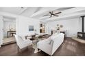 Bright living room with hardwood floors, modern furniture, ceiling fan, and a cozy fireplace at 404 S Jasmine St, Denver, CO 80224