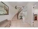 Bright foyer with grand staircase, tiled floors, and elegant decorative touches at 5227 S Geneva St, Englewood, CO 80111