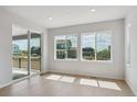 Bright and airy living room with large windows providing abundant natural light and backyard views at 13765 Emerald Lake St, Parker, CO 80138