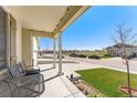 Relaxing front porch with comfortable seating and views of the neighborhood street at 47385 Lily Ave, Bennett, CO 80102