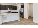 Modern kitchen with stainless steel appliances, a center island with quartz countertops, and hardwood floors at 6751 Arbor E Blvd, Thornton, CO 80602